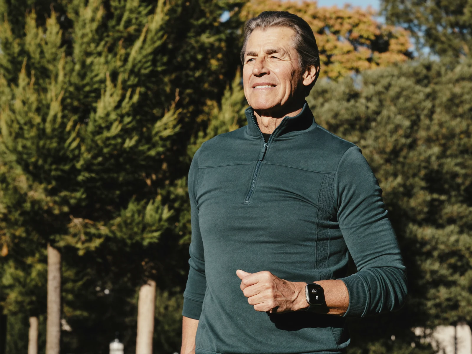 Active senior wearing SafeZone fall detection watch